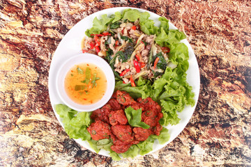 Fried spicy basil with minced pork and curried fish cake.