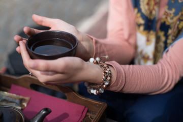 hands holding cup of tea 