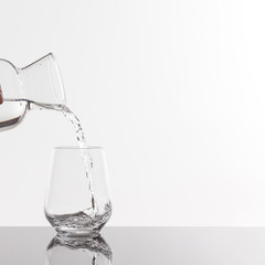 Empty transparent bottle and glass