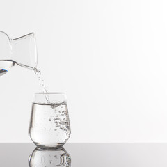 Empty transparent bottle and glass