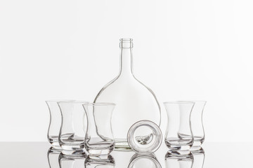 Empty transparent bottle and glass