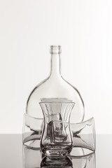 Empty transparent bottle and glass