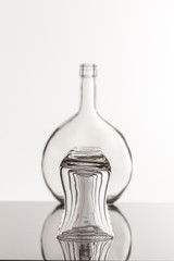 Empty transparent bottle and glass