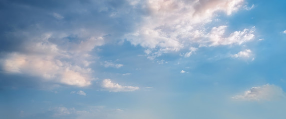 Sky background. Nature composition. Panoramic sunset sky background. Bright blue sky with lighted clouds. 