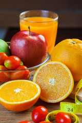 Healthy concept with mixed fruits and vegetables on wooden background