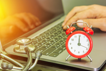 analog clock and stethoscope on the notebook countdown time