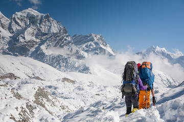 Trekkers crossing Gokyo glacier in Khumbu valley on a way to Everest Base camp