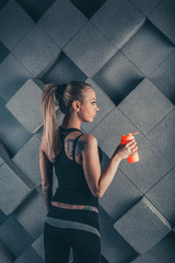 girl after a workout, drinks water