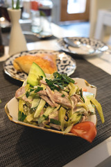 Traditional russian salad with boiled veal tongue, fresh and pickled cucumbers, tomatoes, onions and sour-cream