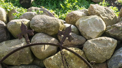 Field stone wall in the garden at sunshine