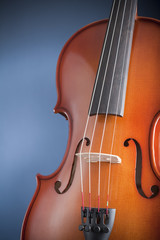 Detail of violin on blue background