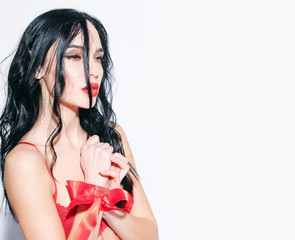 sexy woman with red lips, long hair in bra, ribbon