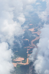 Obraz premium aerial view airplane wing and blue cloud sky, view through window glass see city view