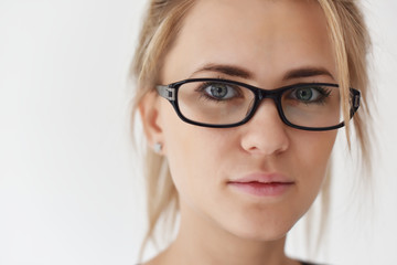 portrait of a blonde girl in black-rimmed glasses and close-up