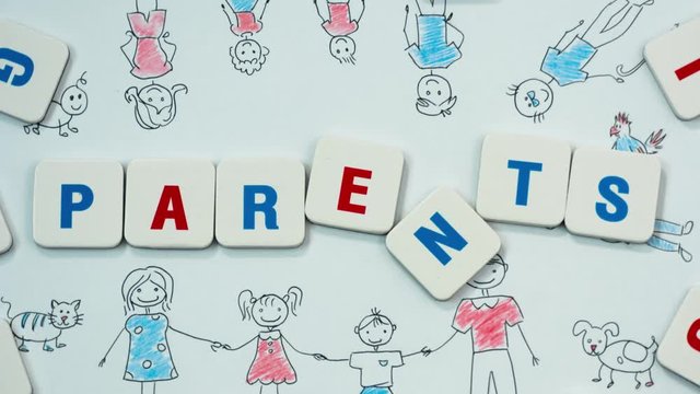 Word PARENTS on the background of the picture of the family. Stop motion