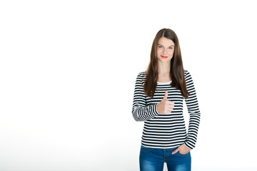 Gorgeous young brunette showing big thumbs up on white background