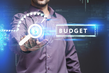 Business, Technology, Internet and network concept. Young businessman working on a virtual screen of the future and sees the inscription: Budget