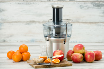 Modern electric juicer and various fruit on kitchen counter, healthy lifestyle concept - obrazy, fototapety, plakaty