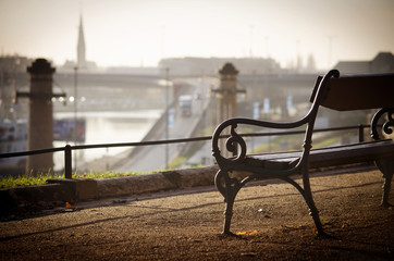 The old bench stands over the Oder River. - obrazy, fototapety, plakaty