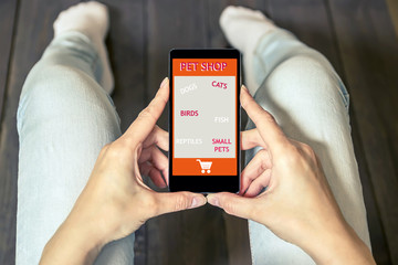 A woman makes a purchase from the online store. Pet shop website. 