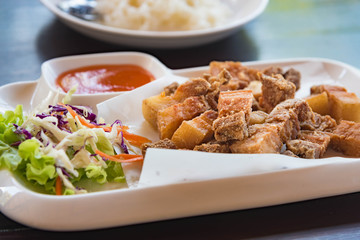 Fried pork with salt in a white plate