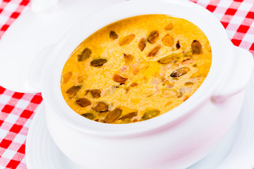 Cream soup with pumpkin in white bowl