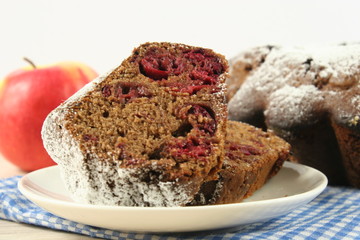 Homemade cherry pie with a knitted cloth on wooden table