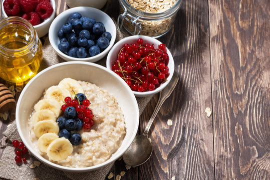 homemade oatmeal with berries and wooden background