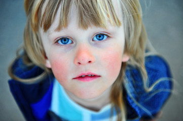 Portrait of a child with long blond hair