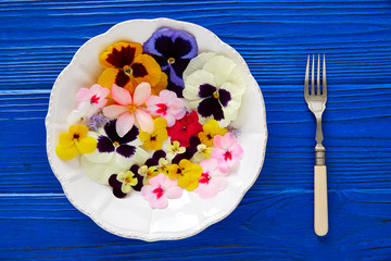 Edible flowers salad in a plate