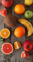 Fresh fruits. Mixed fruits background. Healthy eating, dieting. Background of healthy fresh fruits. Fruit salad - diet, healthy breakfast. pomegranate, persimmon, tangerine, banana, lemon 