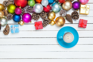 cup of coffee and beautiful christmas decorations on the wonderful white wooden background