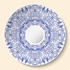 Round blue floral ornament. Styling based on Chinese or Russian porcelain painting. Pattern is applied to ceramic decorative plate.