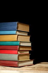 Old antique books on brown wooden table