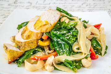 Meat, noodles, bell pepper and salad