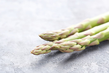 Green asparagus on grey wooden table