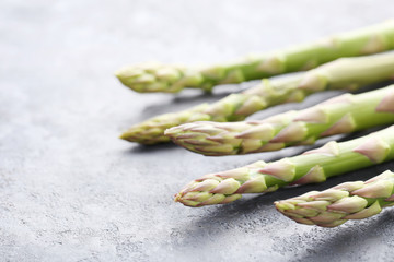 Green asparagus on grey wooden table