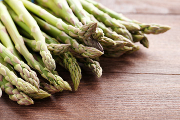 Green asparagus on brown wooden table