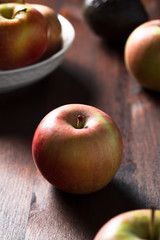 Homegrown ripe apples on rustic table vertical