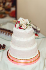 white wedding cake with roses