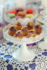 Eclairs with blueberry filling On White Stand.