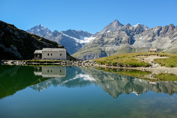 Fototapeta na wymiar Swiss mountains reflected in lake Schwarzsee near Zermatt.