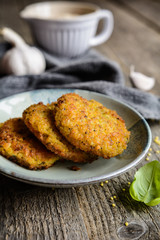 Fried millet patties with oatmeal, carrot, egg, garlic and onion