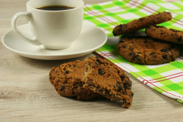 Coffee cup with oatmeal cookie chocolate on wooden background