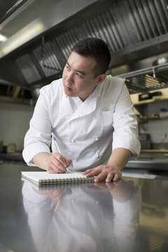 Chinese cook with notebook