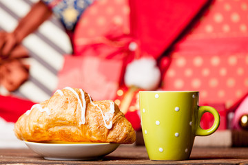 photo of tasty croissant and cup of coffee on the wonderful christmas decorations background