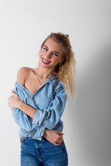 Beautiful girl in jeans and a shirt smiling happy happy