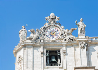 Sculptures and clock on the facade of Vatican city works. Vatican. Rome. Italy.