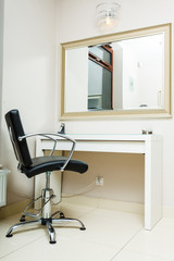 Chair and mirror in hairdresser salon