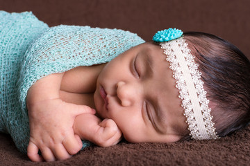 Close up of beautiful baby girl asleep on a blanket